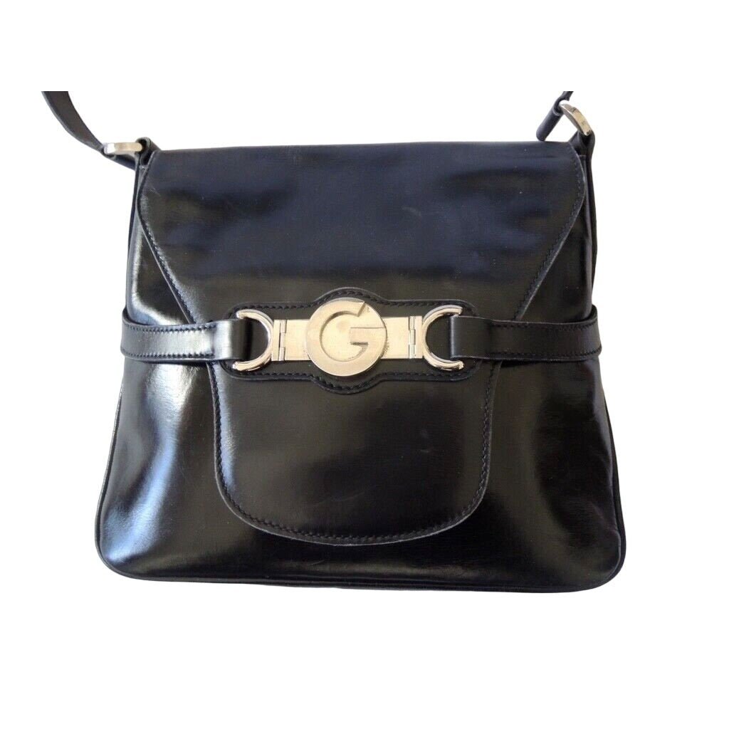 1970s Gucci saddle bag in black leather with muted gold hardware, an expandable bottom, wide shoulder strap, and burgundy leather lining | AlmaBagz - Image 8