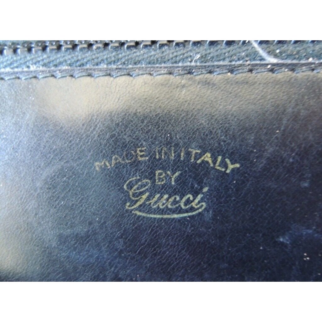 1970s Gucci saddle bag in black leather with muted gold hardware, an expandable bottom, wide shoulder strap, and burgundy leather lining | AlmaBagz - Image 9