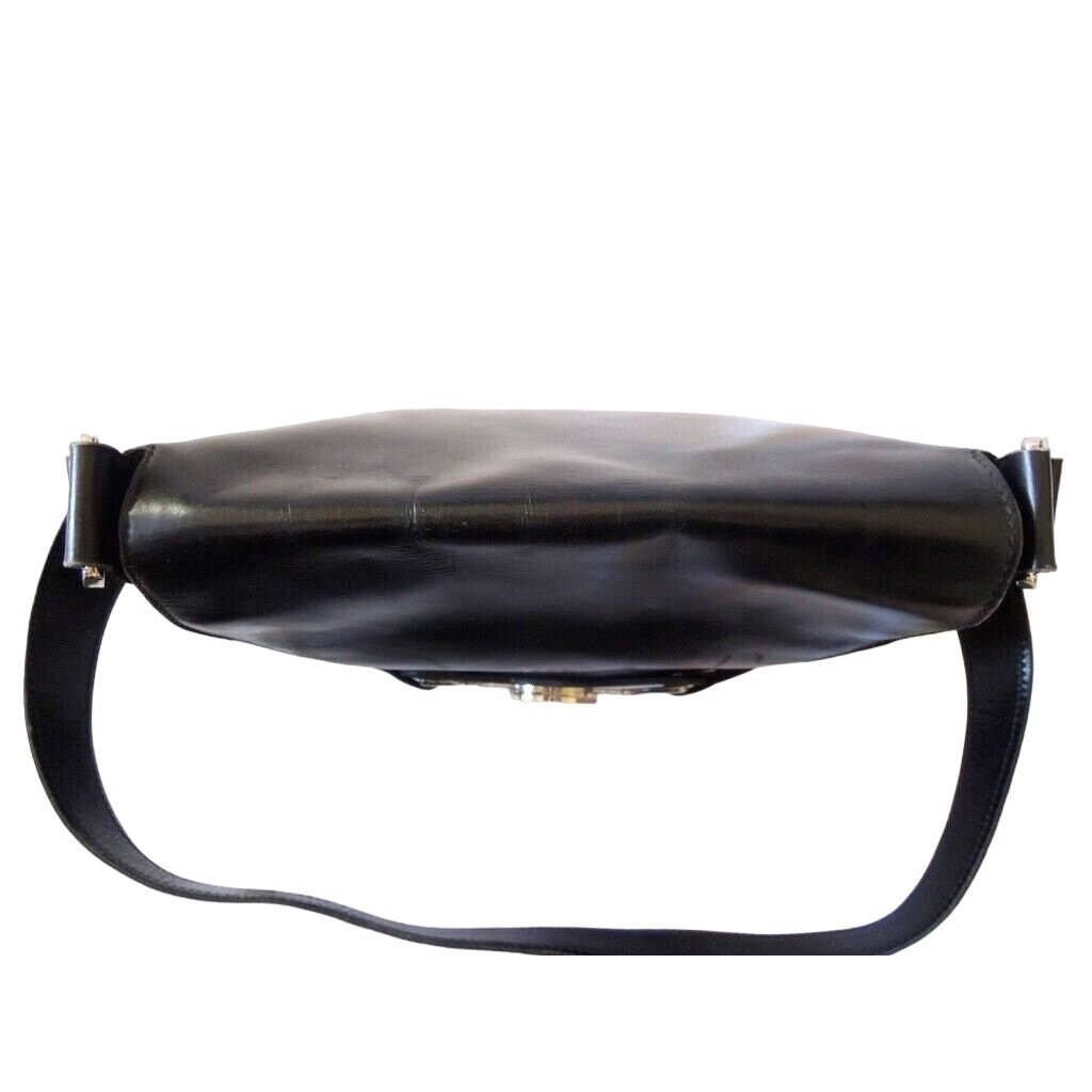 1970s Gucci saddle bag in black leather with muted gold hardware, an expandable bottom, wide shoulder strap, and burgundy leather lining | AlmaBagz - Image 6