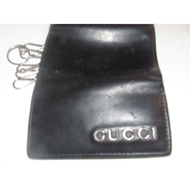 Gucci, black leather, snap close, tri-fold, key holder/card holder, mini- wallet w chrome accents & slots for your cards & six key holders | AlmaBagz